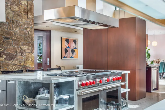 a living room with fireplace furniture and a large window