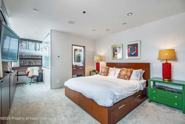 a bedroom with two beds and painted walls