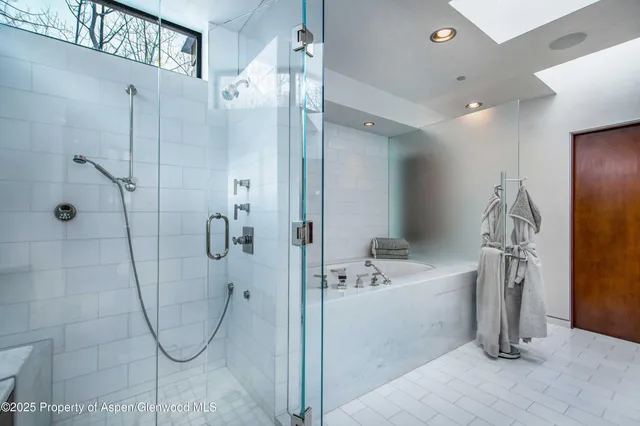 a bedroom with a large bed and a large window