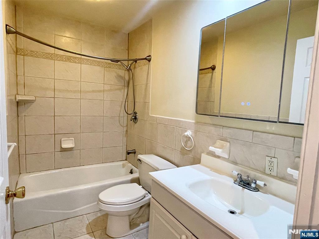 662 Undercliff Avenue, Unit 2 Edgewater, NJ 07020 - Photo 14 of 17 a bathroom with a sink a toilet and shower