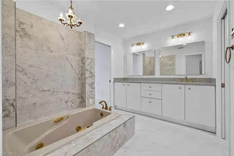 a bathroom with a bathtub a sink and a shower