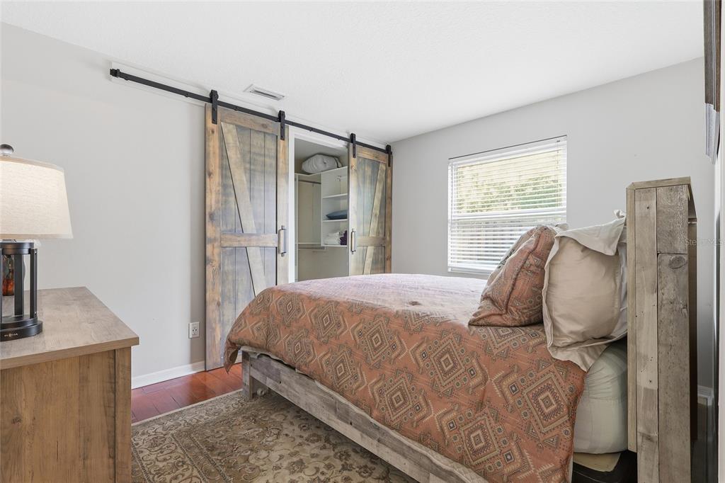 3488 Ridge Boulevard Palm Harbor, FL 34684 - Photo 19 of 30 a bedroom with a bed and dresser with mirror