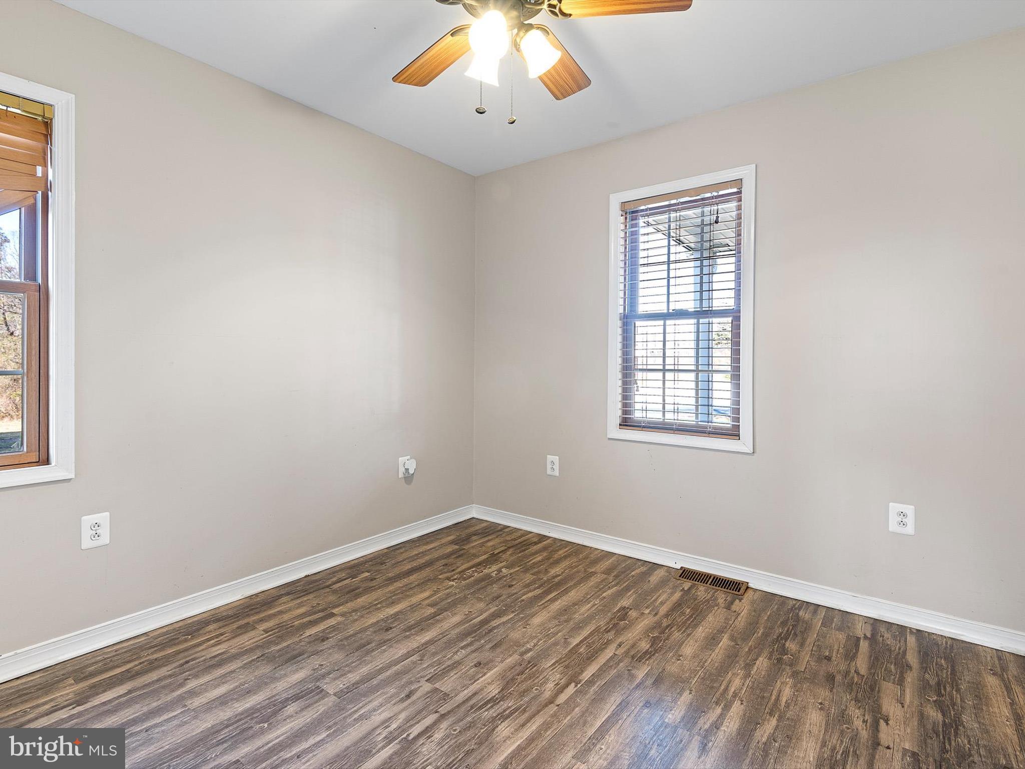 176 Old Mill Road Conowingo, MD 21918 - Photo 17 of 20 an empty room with wooden floor and windows