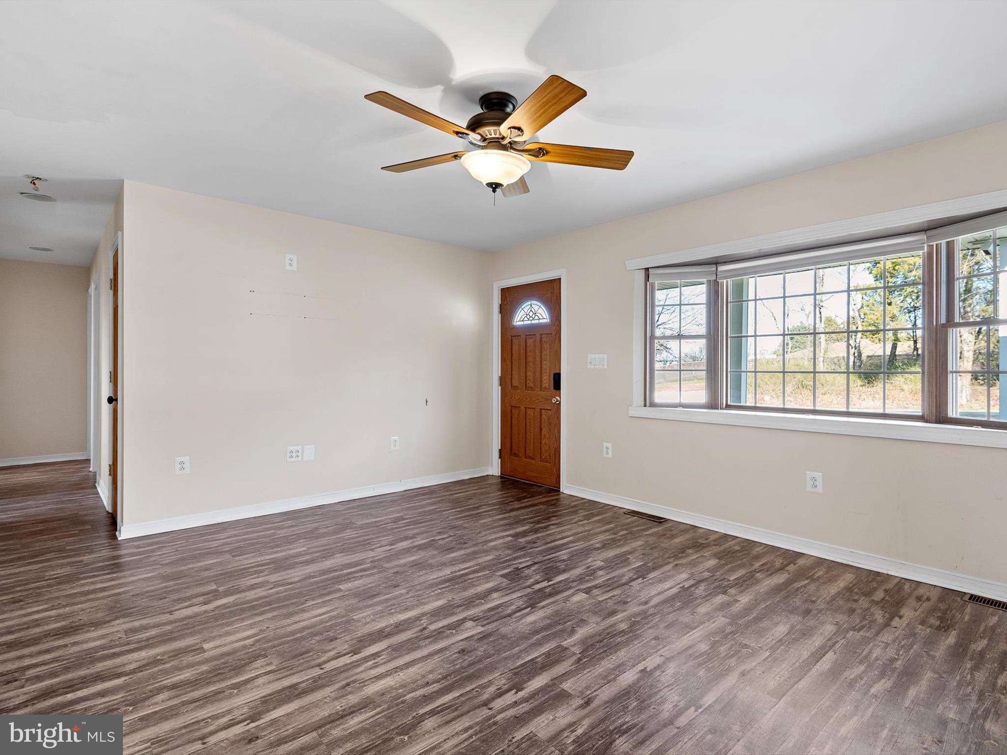 176 Old Mill Road Conowingo, MD 21918 - Photo 8 of 20 a view of an empty room with wooden floor and a window