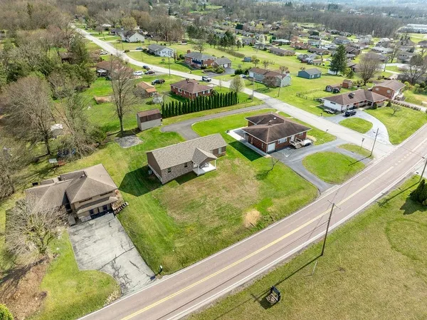 an aerial view of a house with a big yard