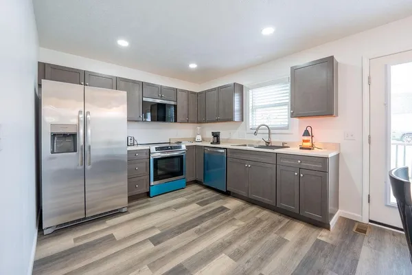a kitchen with stainless steel appliances a stove a microwave and a refrigerator