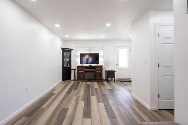 a view of empty room with wooden floor