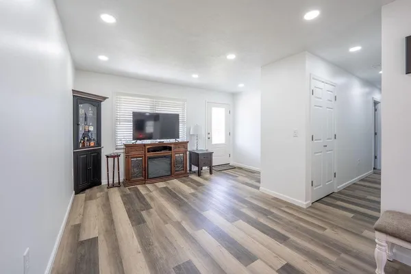 a view of kitchen with furniture and wooden floor