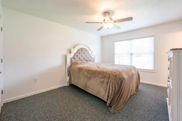 a bedroom with a bed and a chandelier