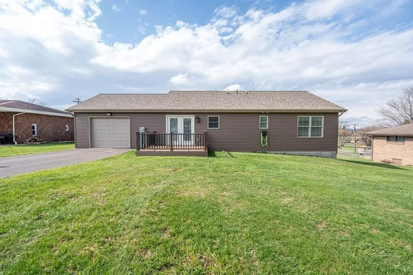 a view of a house with a backyard
