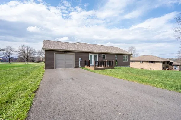 a view of an house with backyard and a garden