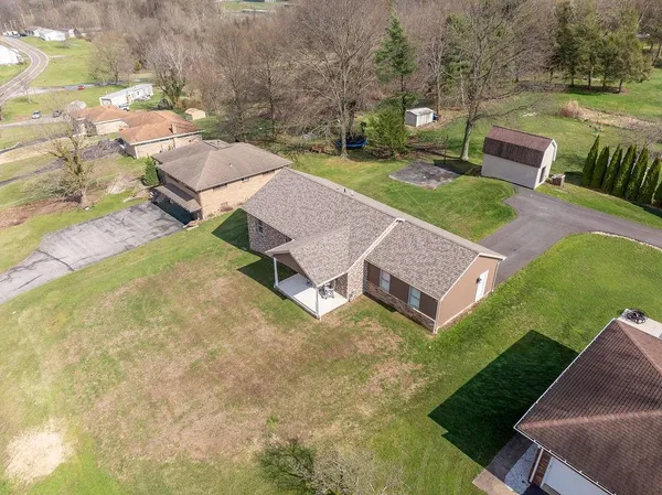 an aerial view of a house with garden space and street view