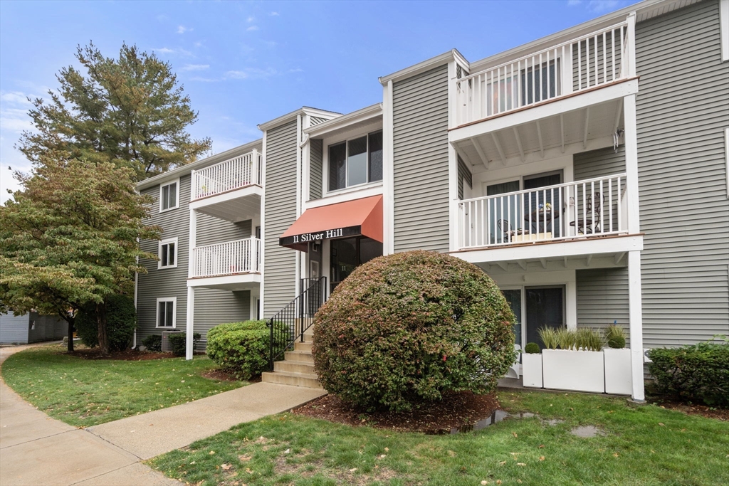 11 Silver Hill Lane, Unit 11 Natick, MA 01760 - Photo 21 of 22 a front view of a house with a yard