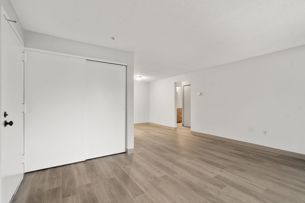 11 Silver Hill Lane, Unit 11 Natick, MA 01760 - Photo 8 of 22 a view of an empty room with wooden floor
