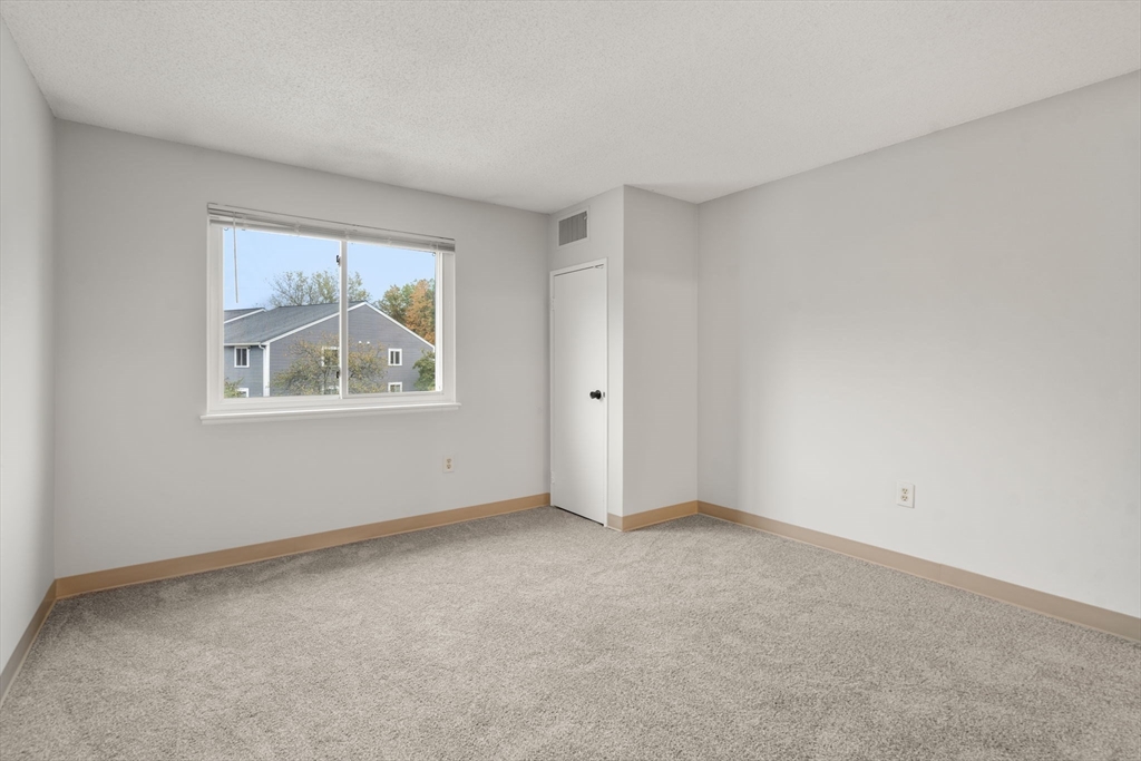 11 Silver Hill Lane, Unit 11 Natick, MA 01760 - Photo 10 of 22 a view of an empty room with a window