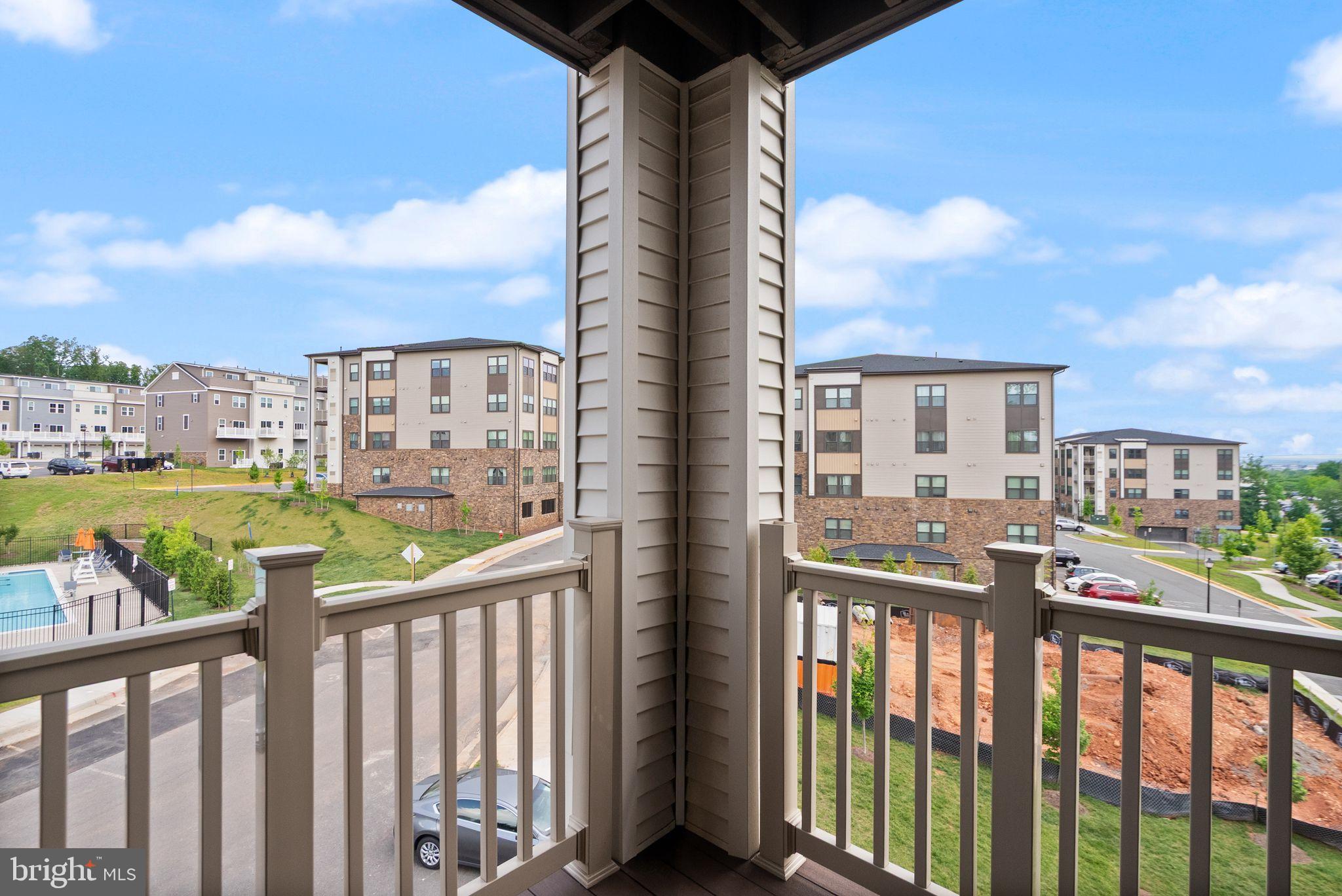 46320 Mount Milstead Terrace, Unit 301 Sterling, VA 20164 - Photo 16 of 24 Scenic balcony view of modern apartments.