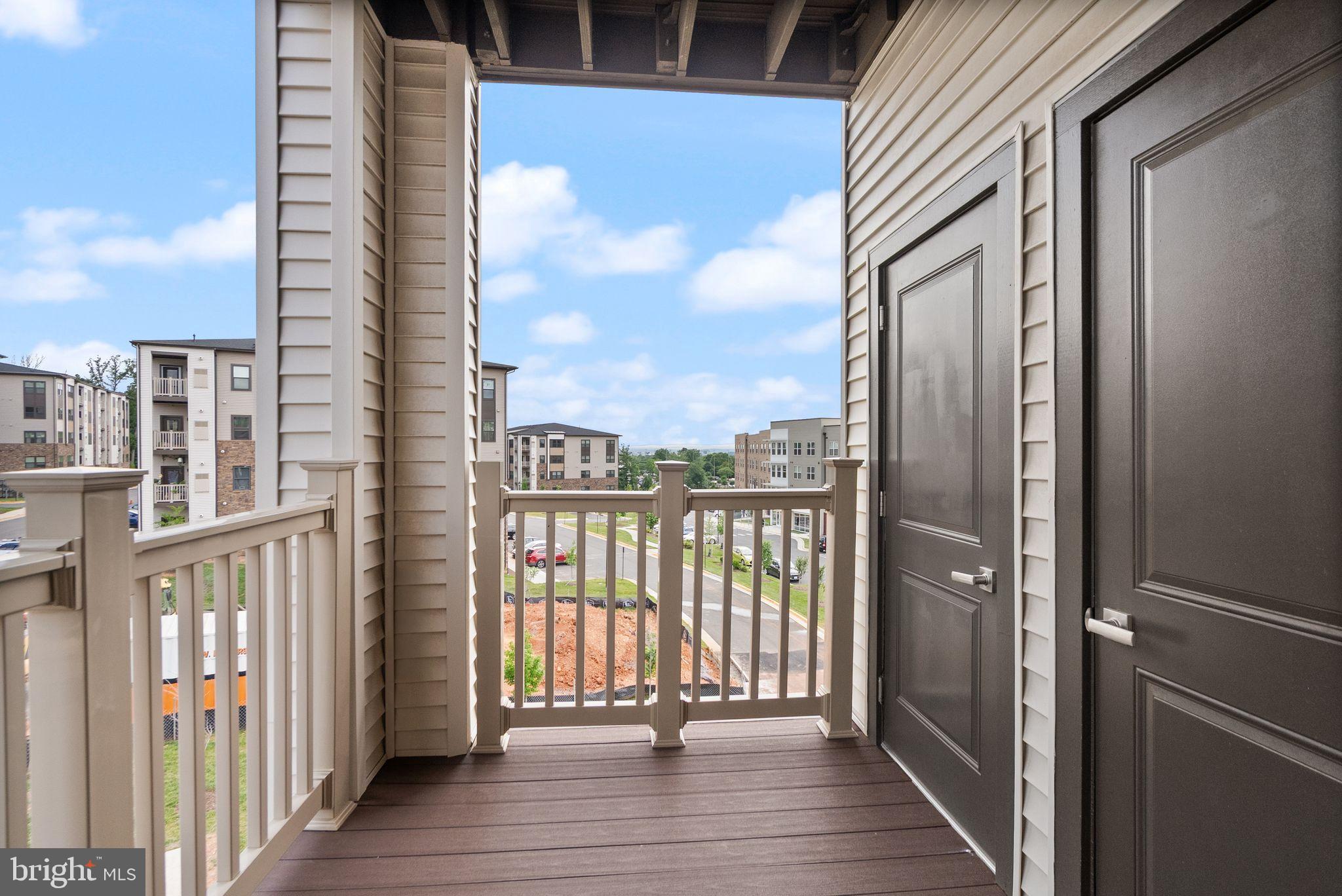 46320 Mount Milstead Terrace, Unit 301 Sterling, VA 20164 - Photo 17 of 24 Sunny balcony with a view of community life.