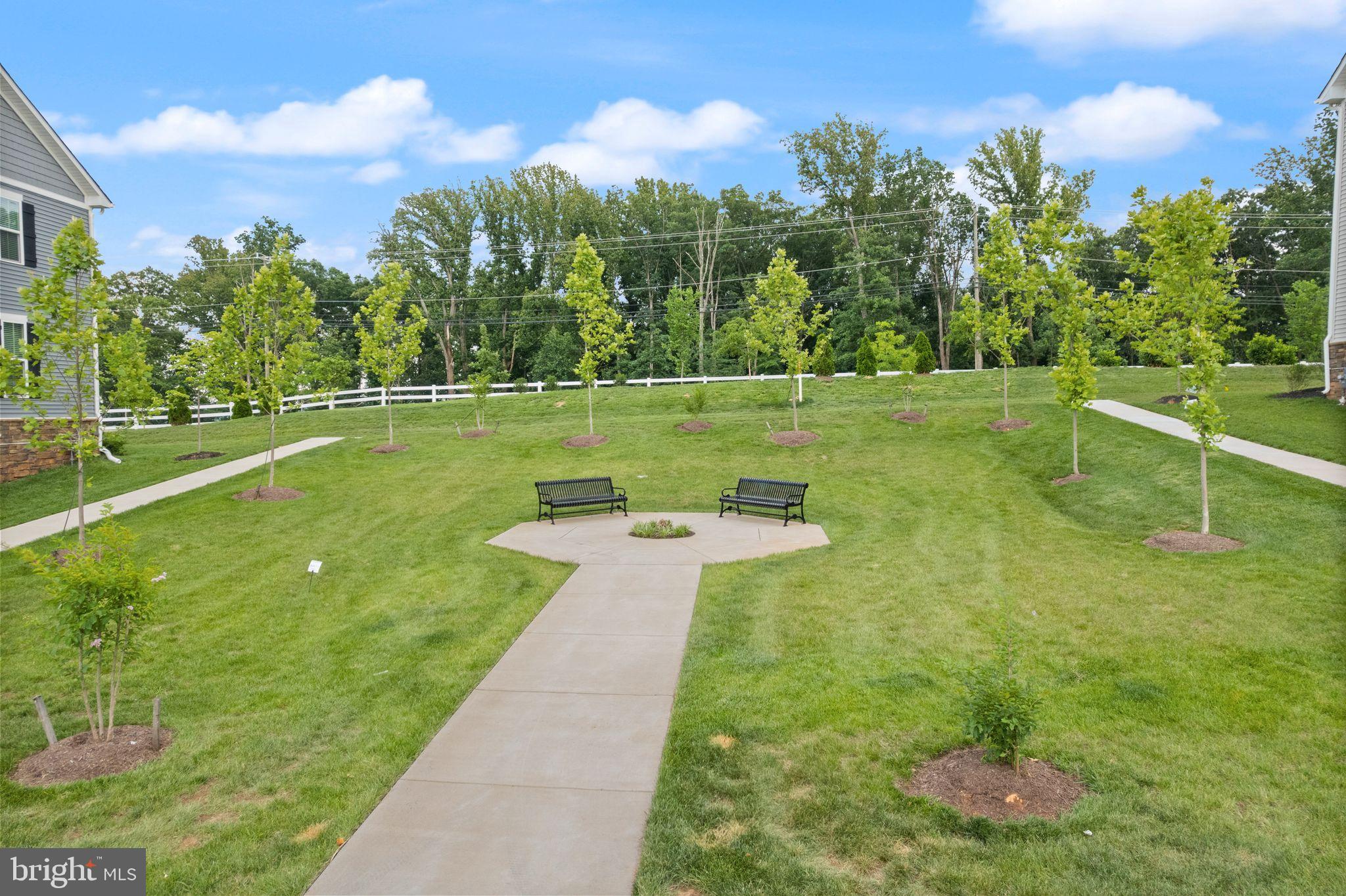 46320 Mount Milstead Terrace, Unit 301 Sterling, VA 20164 - Photo 21 of 24 Serene green space with inviting pathways.