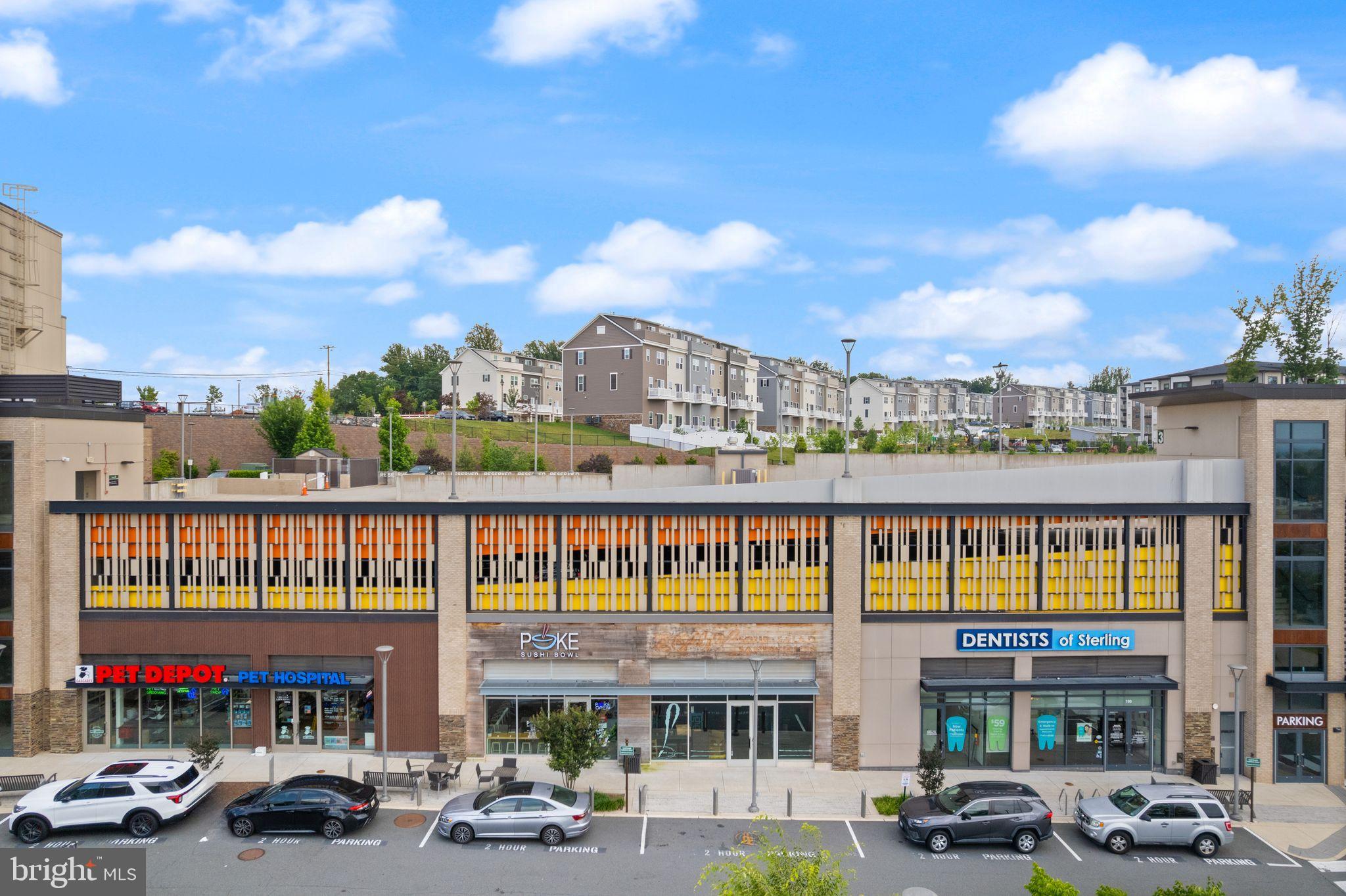 46320 Mount Milstead Terrace, Unit 301 Sterling, VA 20164 - Photo 22 of 24 Vibrant retail hub with scenic backdrop.