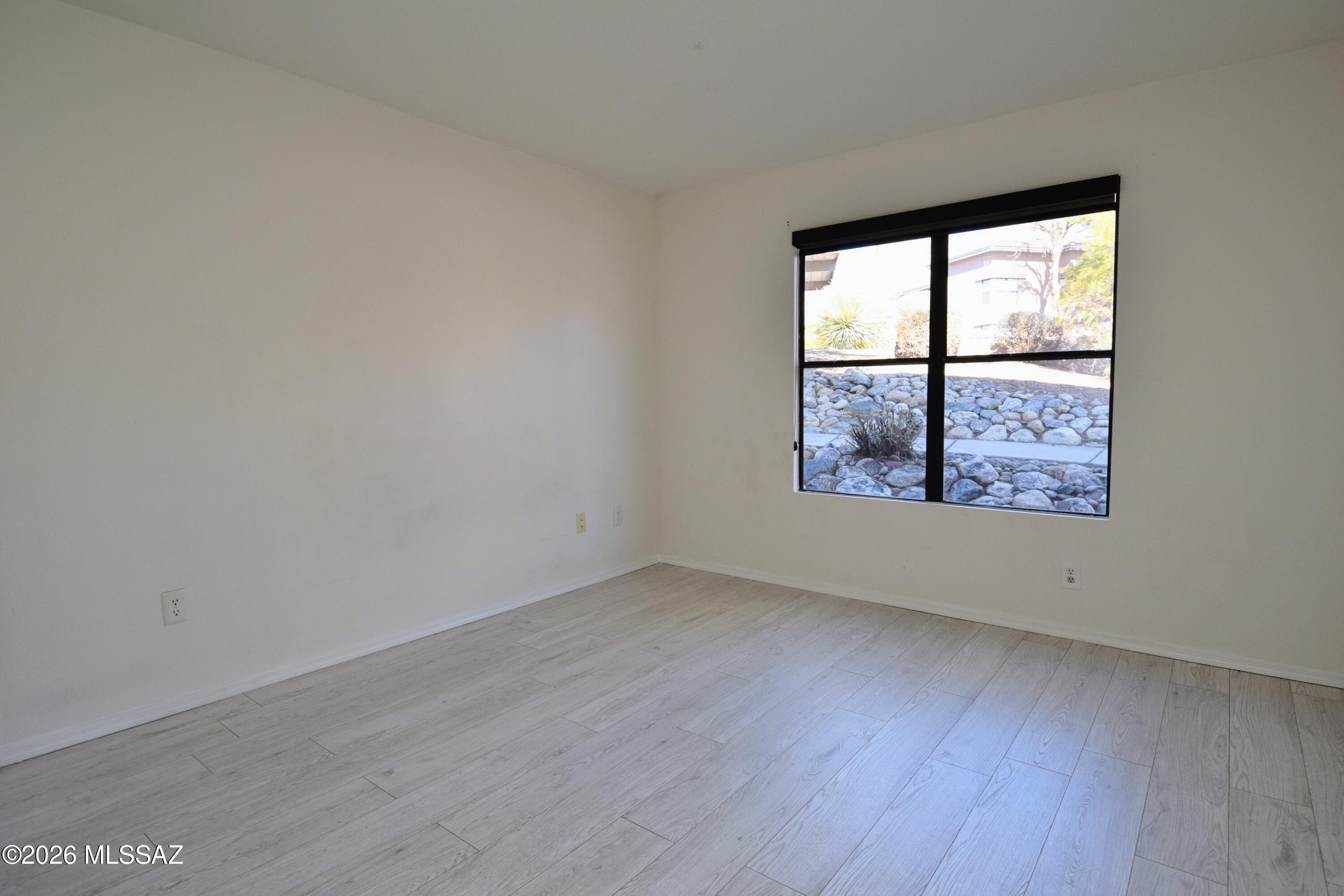 5855 North Kolb Road, Unit 11106 Tucson, AZ 85750 - Photo 17 of 36 an empty room with wooden floor and windows