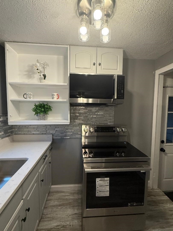 36 Daley Street Chicopee, MA 01013 - Photo 10 of 31 a kitchen with a stove and a microwave