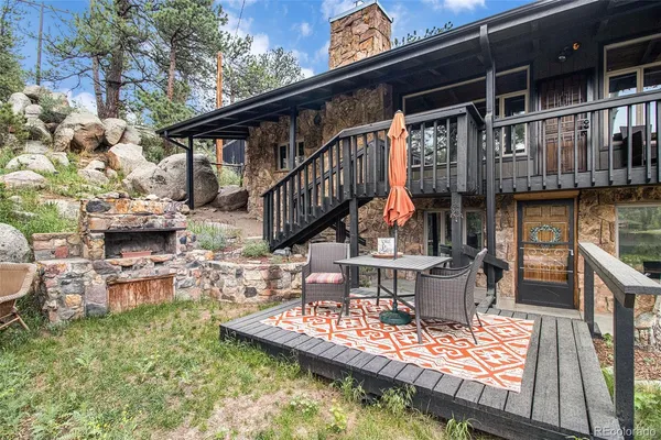 a view of house with roof deck and seating space