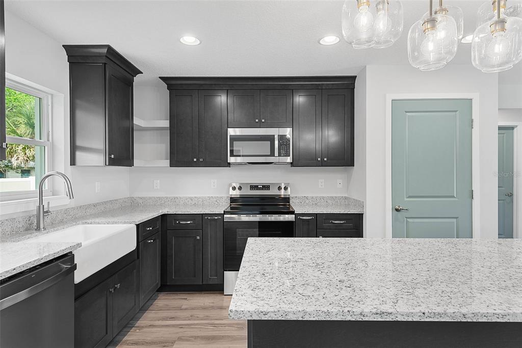 261 South Main Street Bunnell, FL 32110 - Photo 15 of 56 a kitchen with a sink appliances and cabinets