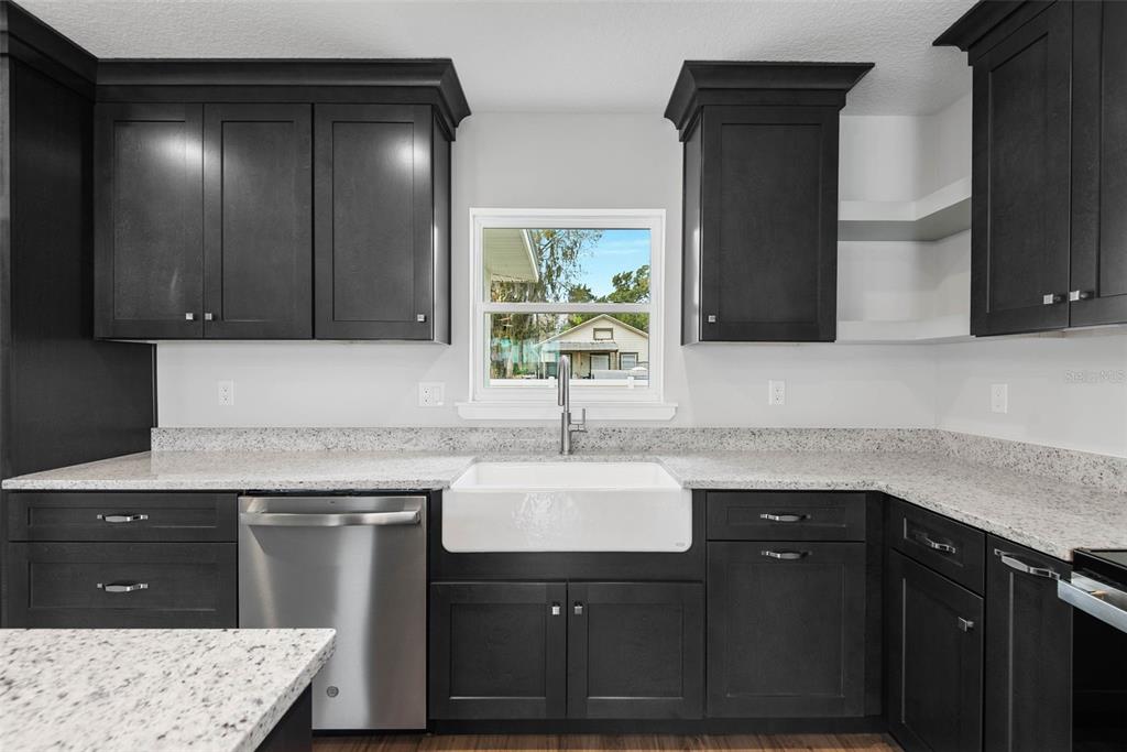 261 South Main Street Bunnell, FL 32110 - Photo 17 of 56 a kitchen with a sink and a wooden cabinets