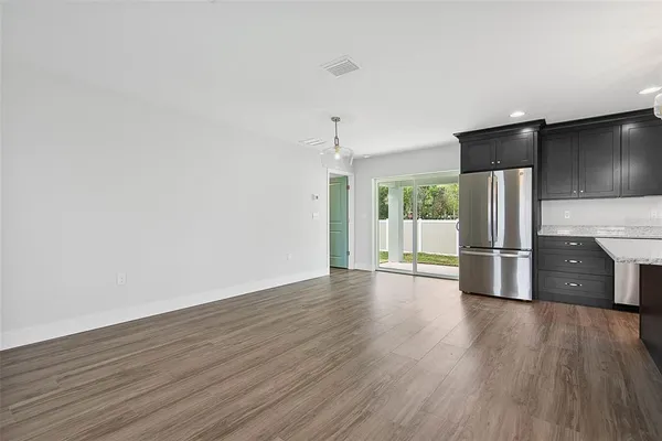 a view of an empty room with wooden floor