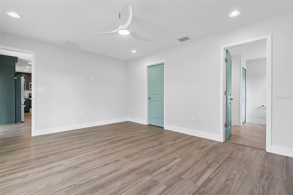 261 South Main Street Bunnell, FL 32110 - Photo 22 of 56 an empty room with wooden floor and windows