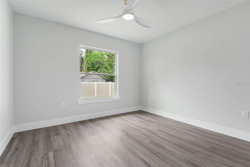 261 South Main Street Bunnell, FL 32110 - Photo 28 of 56 a view of an empty room with wooden floor and a window