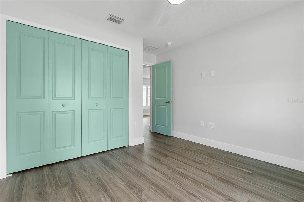 261 South Main Street Bunnell, FL 32110 - Photo 29 of 56 an empty room with wooden floor & closet area