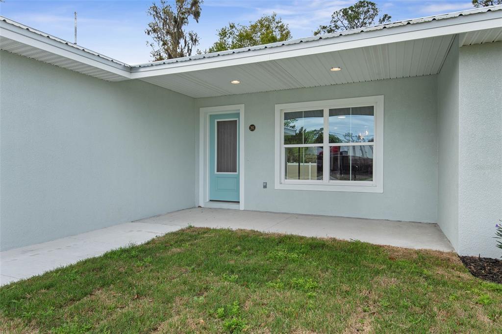 261 South Main Street Bunnell, FL 32110 - Photo 3 of 56 front view of a house with a yard