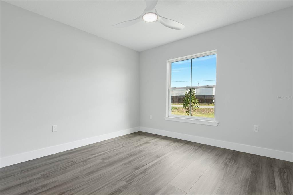 261 South Main Street Bunnell, FL 32110 - Photo 32 of 56 an empty room with wooden floor and windows