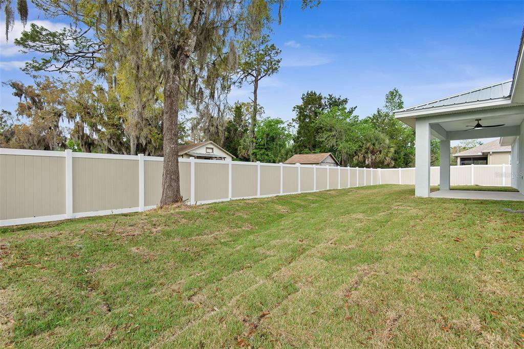261 South Main Street Bunnell, FL 32110 - Photo 35 of 56 a view of an house with backyard and a tree