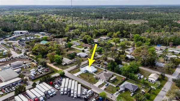 a aerial view of a house with a yard and garage