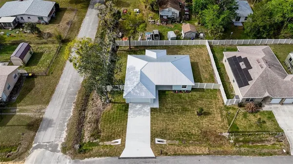 a view of a house with a yard and sitting area