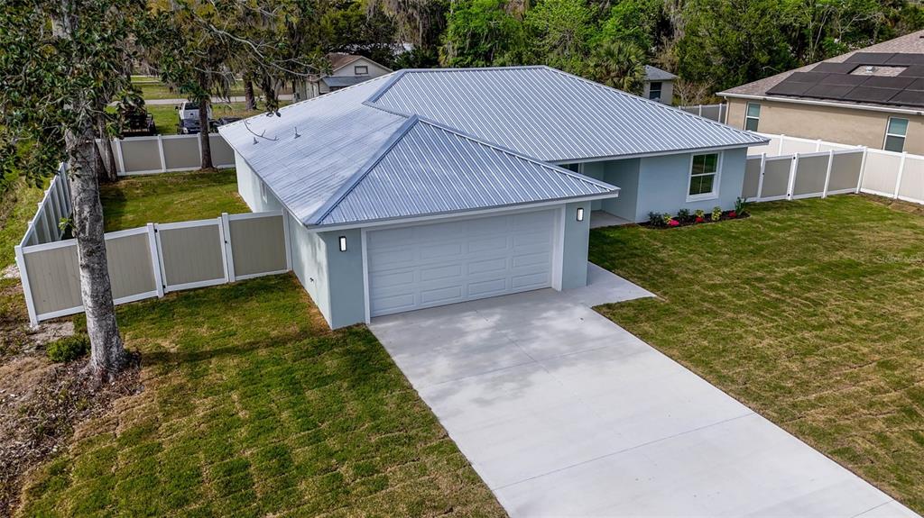 261 South Main Street Bunnell, FL 32110 - Photo 52 of 56 a aerial view of a house with a yard and garage