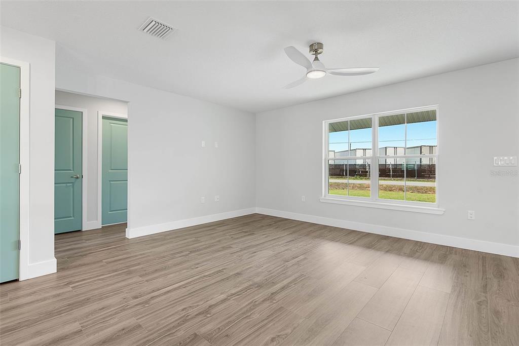 261 South Main Street Bunnell, FL 32110 - Photo 7 of 56 wooden floor in an empty room with a window