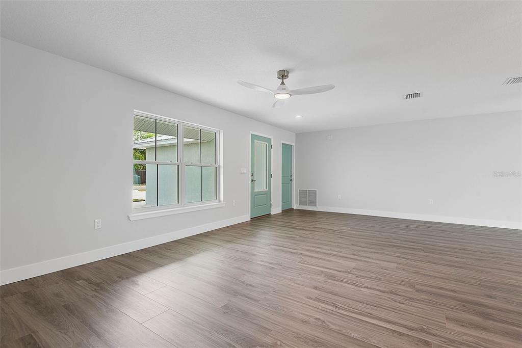261 South Main Street Bunnell, FL 32110 - Photo 8 of 56 an empty room with wooden floor and windows