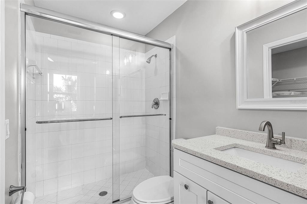 2060 Matecumbe Key Road, Unit 2307 Punta Gorda, FL 33955 - Photo 13 of 45 a bathroom with a granite countertop sink toilet and shower