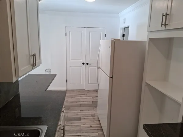 a area with wooden floor and cabinets