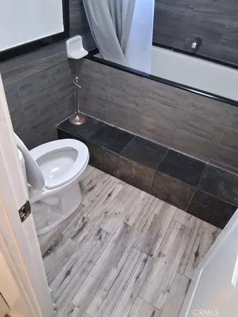 a bathroom with a toilet and a shower
