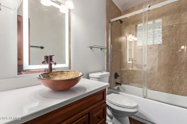 a bath room with a toilet and a shower