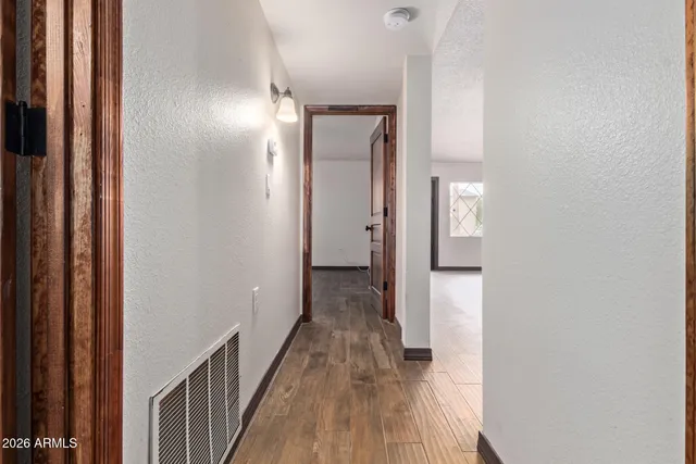 a view of a hallway with wooden floor