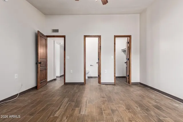 a view of empty room with wooden floor