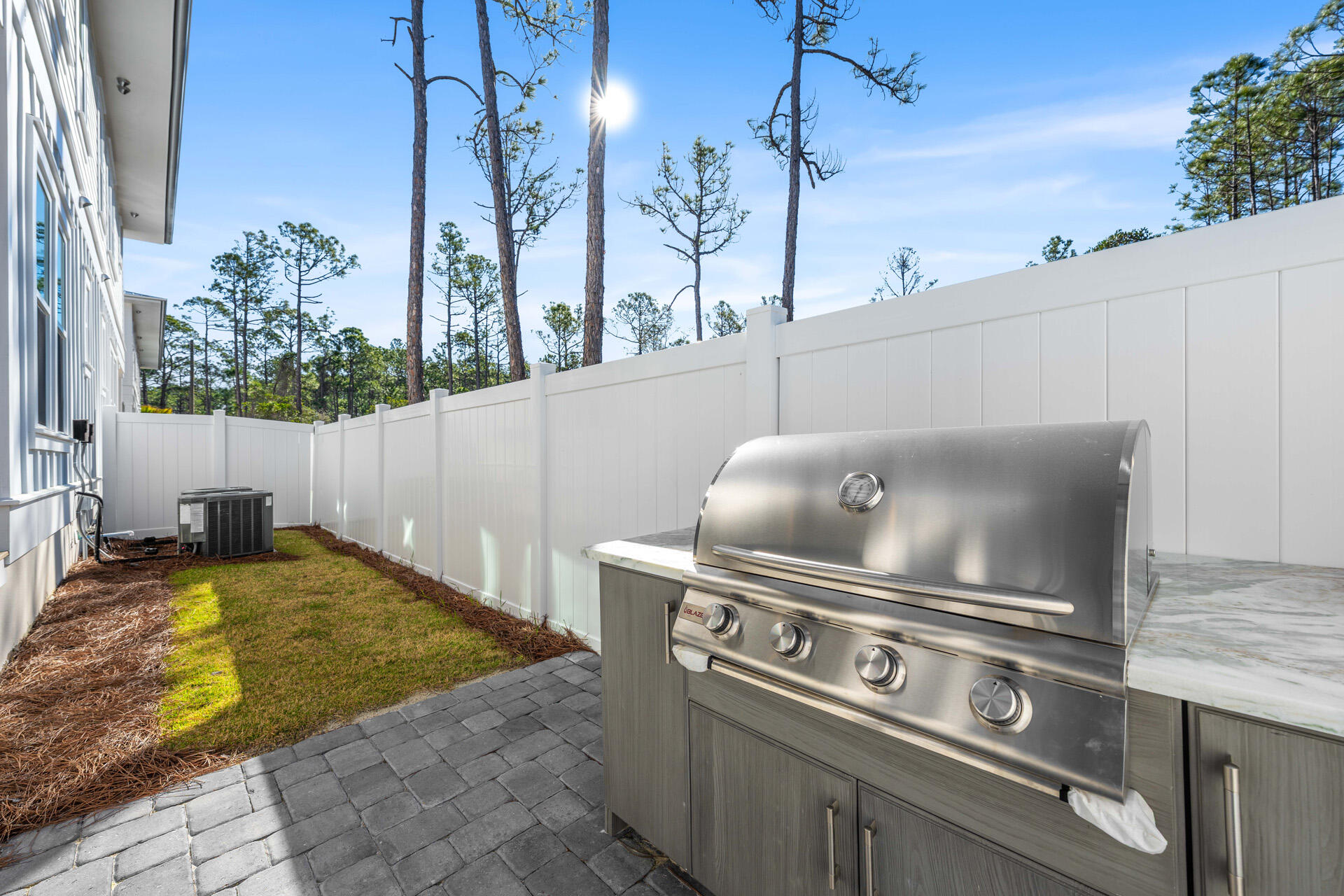 520 South County Highway 393, Unit 39A Santa Rosa Beach, FL 32459 - Photo 40 of 47 a view of a backyard with barbeque grill and iron fence