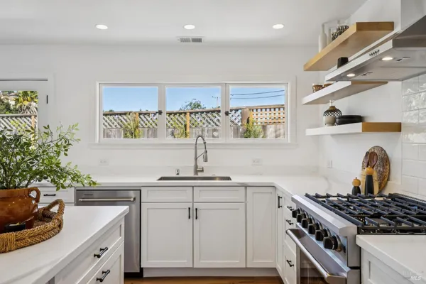 a bedroom with a bed and painting on the wall
