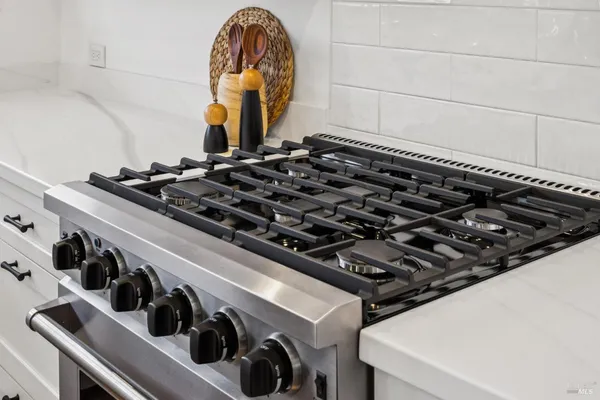 a bedroom with a bed and painting on the wall