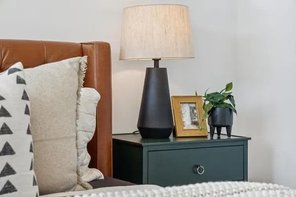a spacious en suite bathroom with a granite countertop sink and a mirror